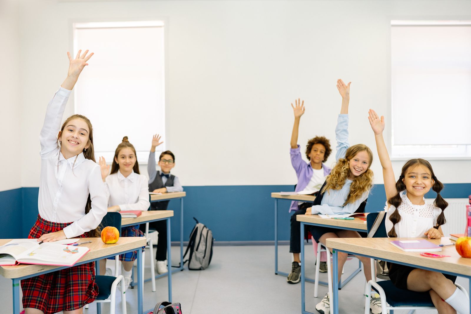 Academy classroom with students raising hands